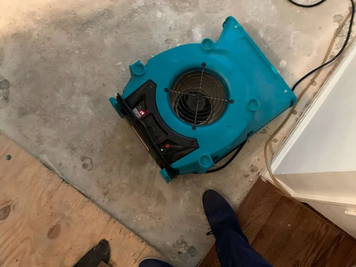 Air mover drying subfloor during Leak Detection & Repair in Firestone
